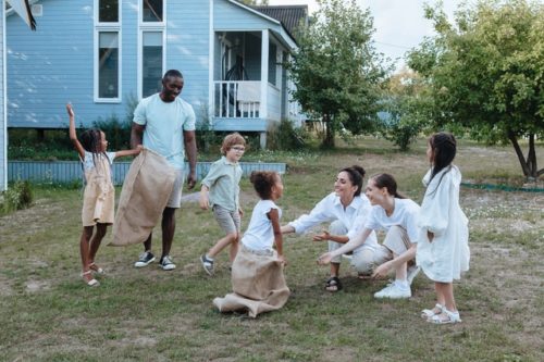 Children and parents playing in the backyard