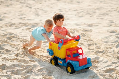Two boys playing in the sand