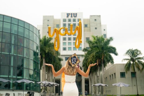 A person standing in front of the FIU building.