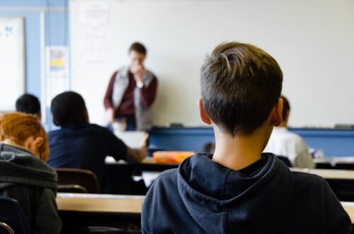 A boy sitting in class at school.