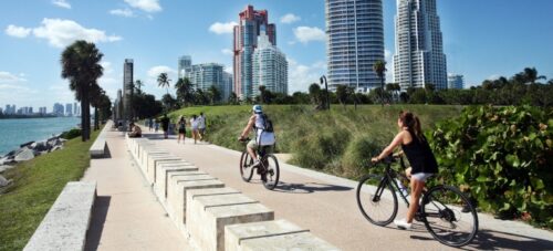 People biking near water