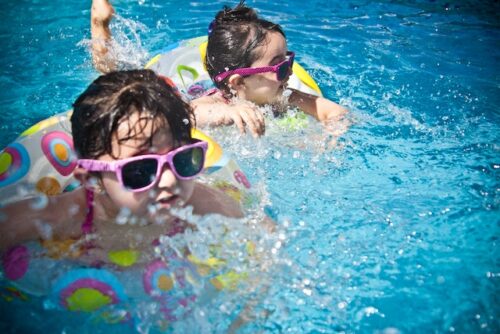 Kids having fun in the swimming pool.