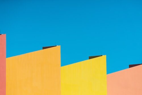 Multicolor museum walls against blue skies depict events and activities in Miami