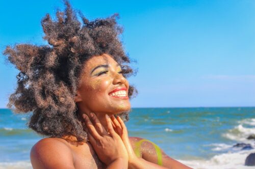 A woman smiling at the beach