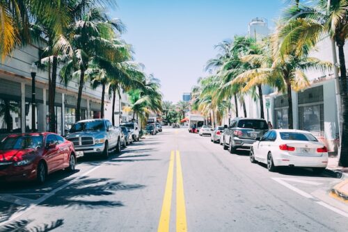 a photo of a street with parked cars in Miami