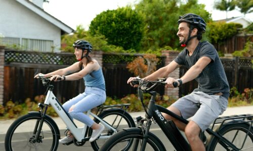 Man and woman biking around a neighborhood