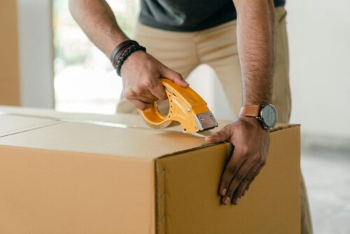 A man packing a box while following Connecticut's storage regulations